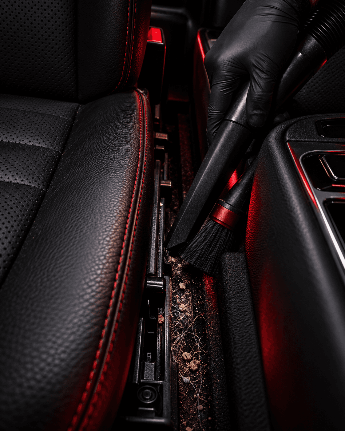 Detailer cleaning dust from a dashboard vent with a fine brush